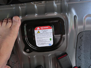Battery service plug access under rear seat