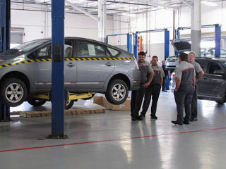 Gaggle of techs around the car