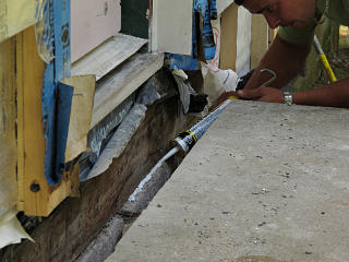 Caulking sill past front stoop slot