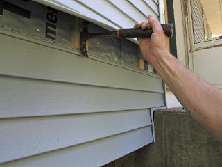 Accessing under siding