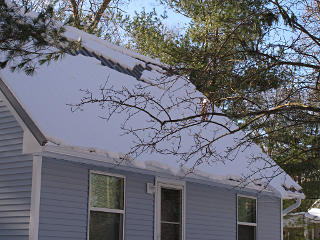Snow mass sliding down roof