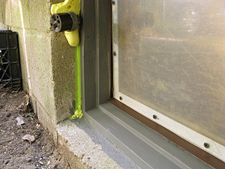 Refitted 'keeper' basement window with sill-flashing lip