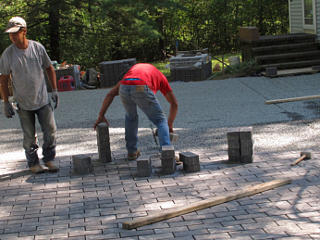 Laying pavers with both hands
