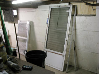 Storm door stashed in basement