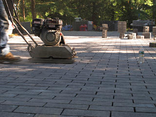 Vibrating paver layer down