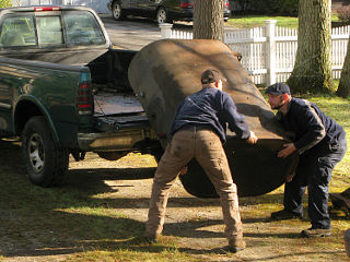 Oil tank hucked into a pickup bed, and taken away