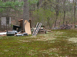 Various piles of junk in backyard