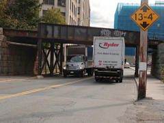 Trucks passing under RR bridge