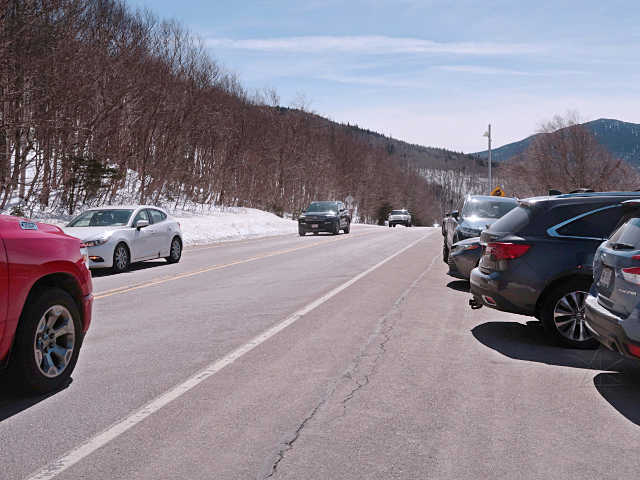 Cars fleeing eastward over the pass away from cloud layer