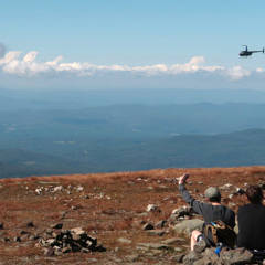 Helicopter rising out of the valley