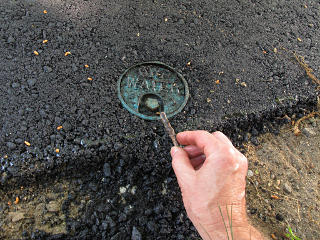 Clearing asphalt out of water cover