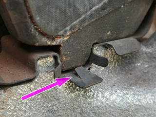 Tiny retainer tab on the pad clips