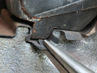 Squeeze the tab with pliers