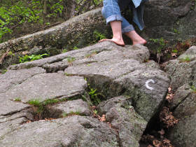 Bare feet adapting to rock