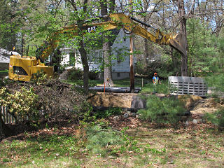 Excavator almost tipping on heavy load