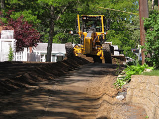 Grading the reclaimed material