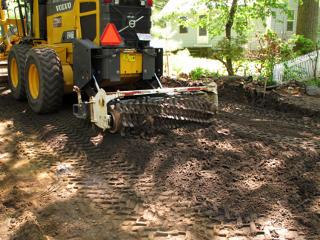 Tenderizer breaking up pavement