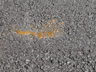 Water boiling out of asphalt