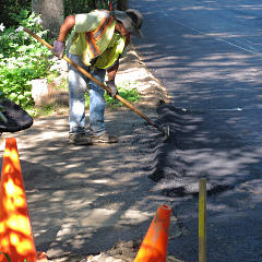 Berm to direct water past driveway