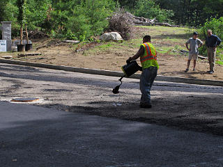 Spreading liquid tar sealer