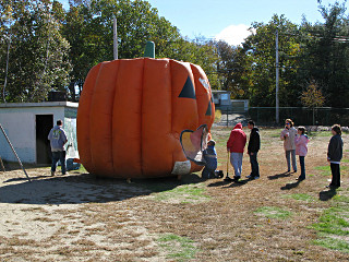 Pumpkin-shaped moonbounce, up